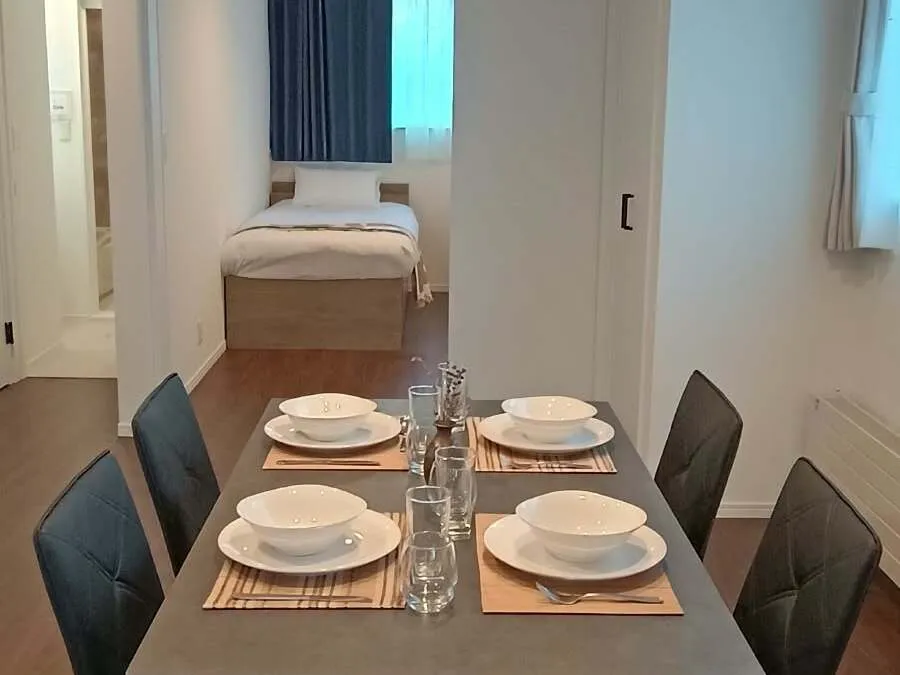 Dining table with a view through the doorway to a bedroom