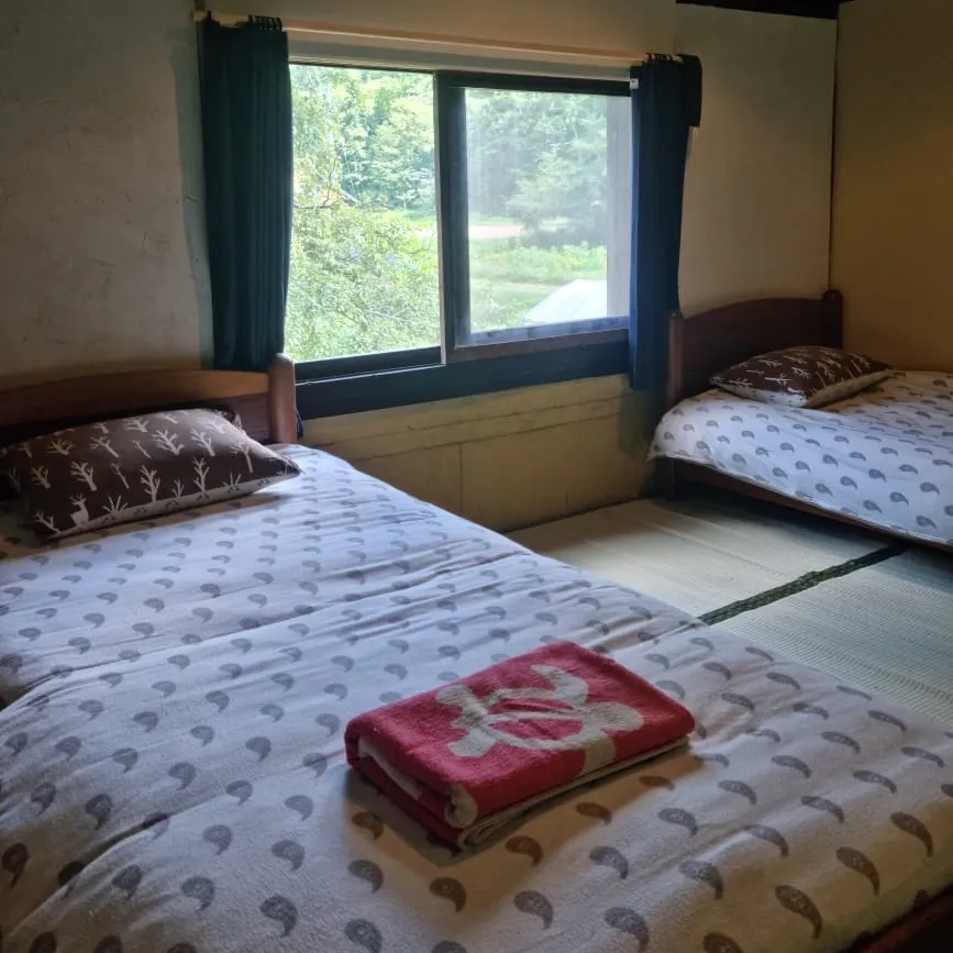 Tatami bedroom with two single beds and garden view